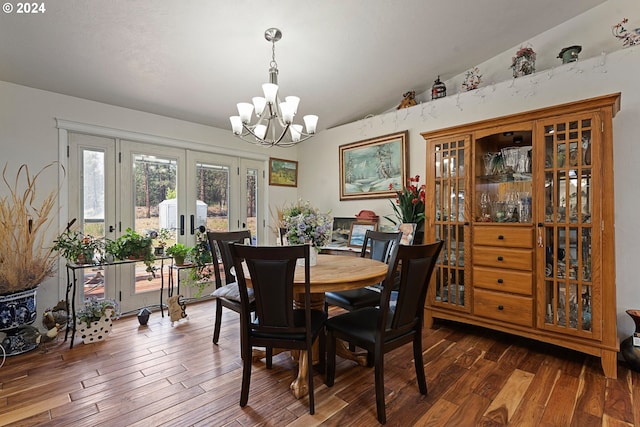 dining room with french doors, lofted ceiling, dark hardwood / wood-style floors, and a notable chandelier