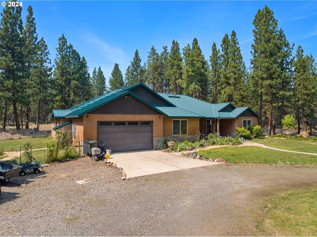 ranch-style home featuring a garage and a front yard