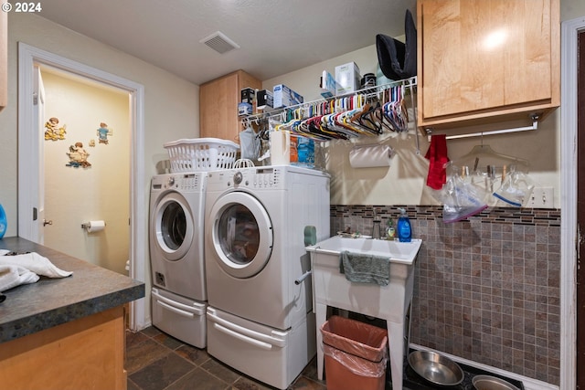 laundry area featuring washer and clothes dryer and tile walls