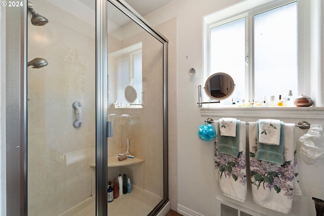 bathroom with a shower with door