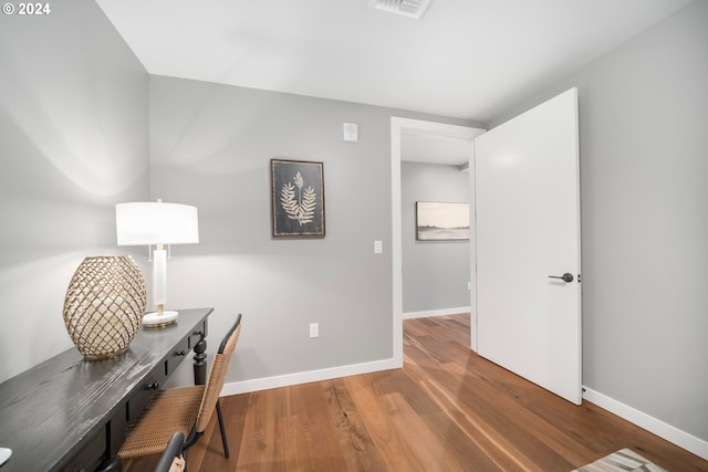 home office with hardwood / wood-style flooring