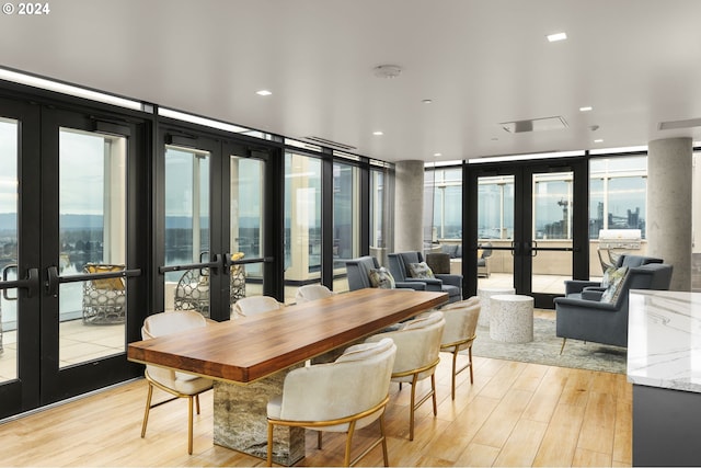 dining space featuring french doors and a healthy amount of sunlight