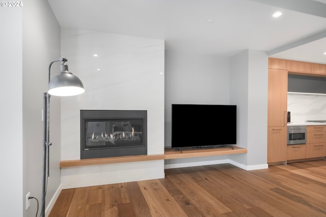 unfurnished living room with light hardwood / wood-style flooring