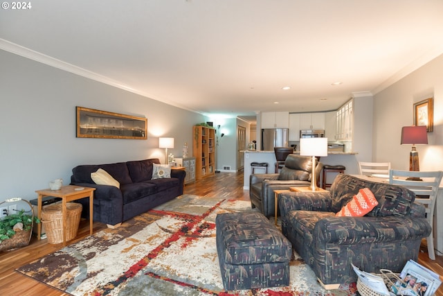 living room featuring hardwood / wood-style floors and ornamental molding