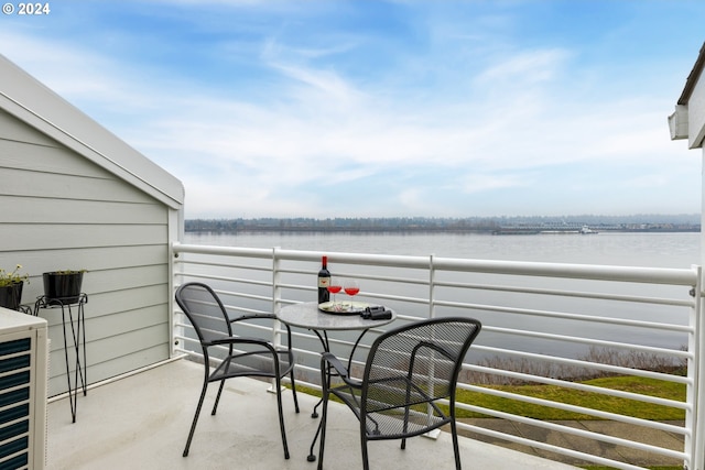 view of patio / terrace featuring a water view and a balcony