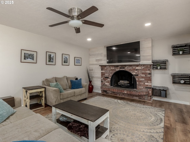 15836 SW Division St, Sherwood, OR 97140 - living area with wood finished floors, a ceiling fan, a fireplace, recessed lighting, and baseboards