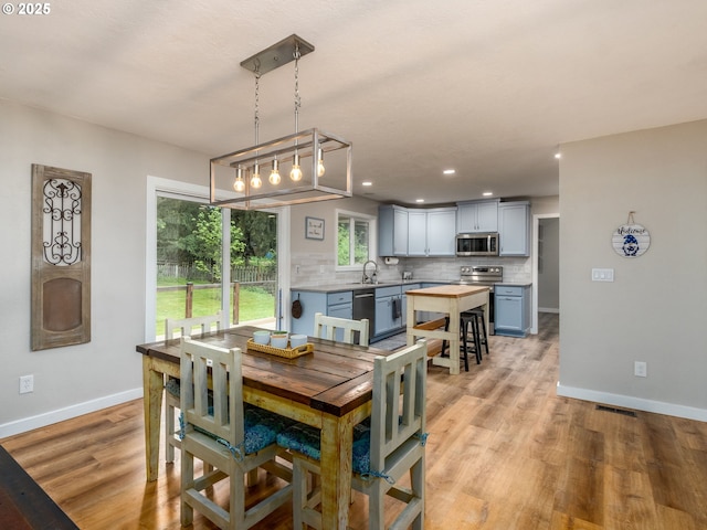 15836 SW Division St, Sherwood, OR 97140 - dining area with baseboards, light wood-style flooring, and recessed lighting