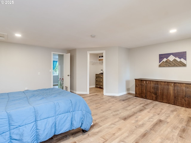 15836 SW Division St, Sherwood, OR 97140 - bedroom with light wood-style floors, recessed lighting, baseboards, a walk in closet, and a closet