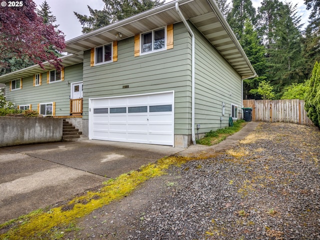 15836 SW Division St, Sherwood, OR 97140 - view of side of property with concrete driveway, an attached garage, and fence