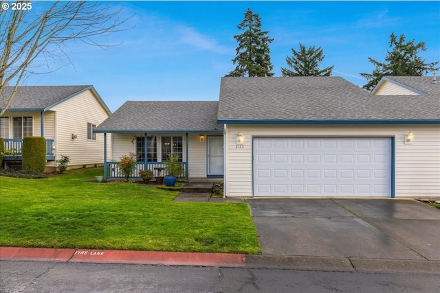 view of front of property with a porch, a garage, and a front lawn