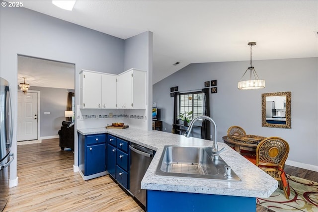 kitchen with blue cabinets, sink, appliances with stainless steel finishes, decorative light fixtures, and white cabinetry