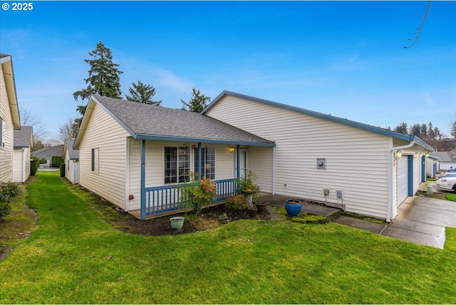 view of front of property with a porch, a garage, and a front lawn