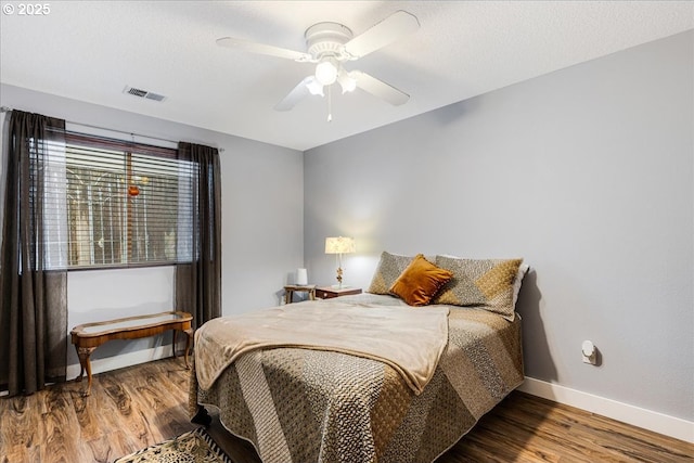 bedroom with hardwood / wood-style floors and ceiling fan