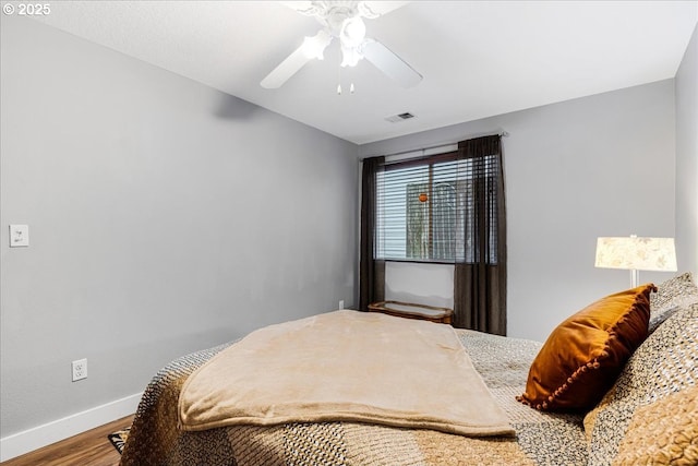 bedroom with hardwood / wood-style floors and ceiling fan