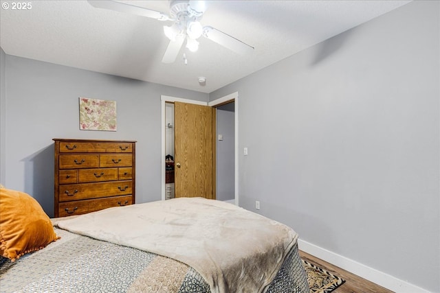 bedroom with ceiling fan and hardwood / wood-style flooring