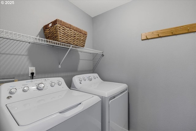 clothes washing area featuring independent washer and dryer