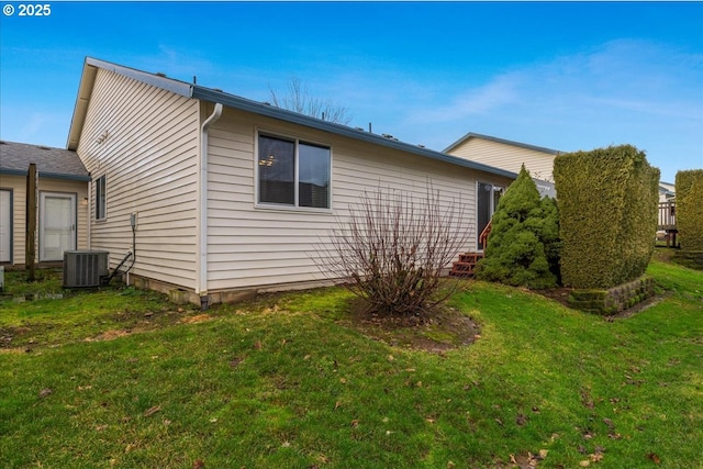 view of property exterior featuring a yard and central AC unit