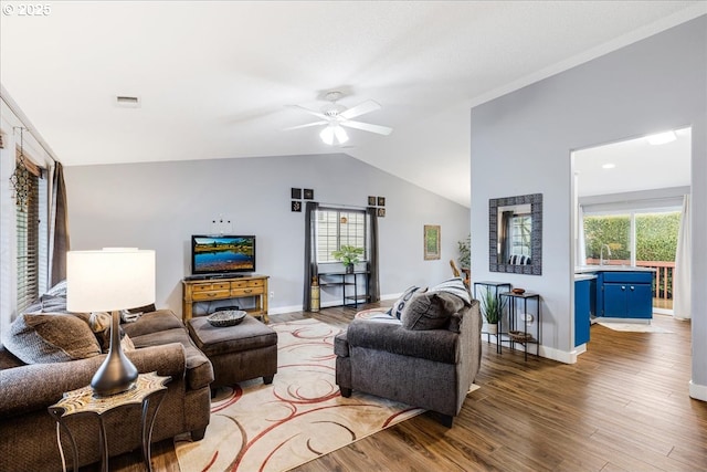 living room with hardwood / wood-style flooring, a wealth of natural light, lofted ceiling, and ceiling fan