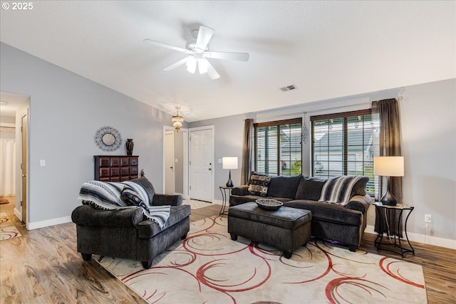 living room with ceiling fan and light hardwood / wood-style flooring