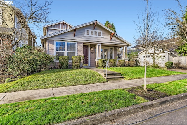 view of front facade with a porch, a front yard, and fence