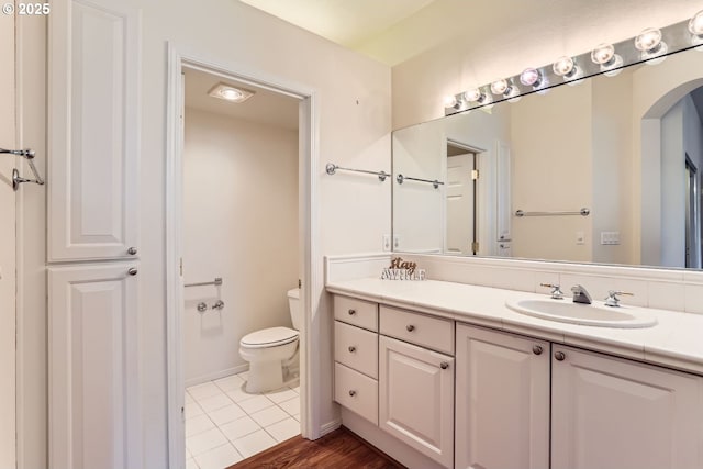 bathroom with tile patterned floors, vanity, and toilet