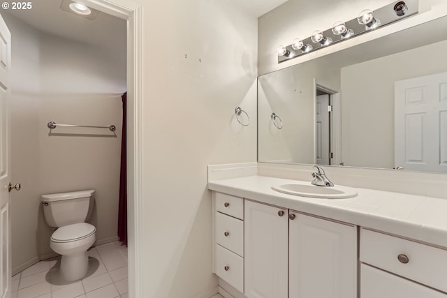 bathroom with tile patterned floors, vanity, and toilet