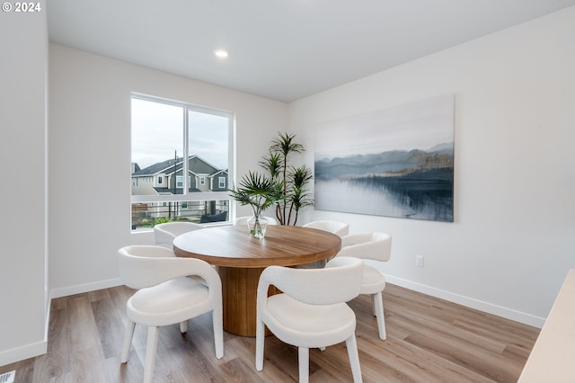 dining space with light hardwood / wood-style floors