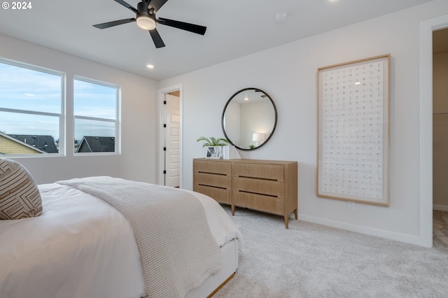 bedroom with ceiling fan and light colored carpet