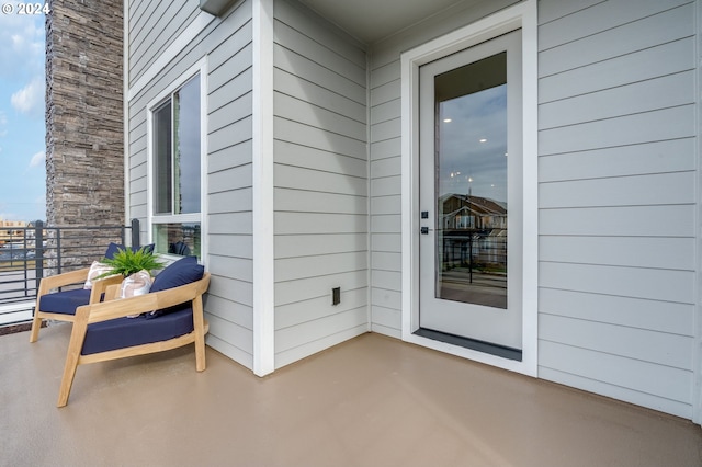 view of exterior entry featuring a balcony