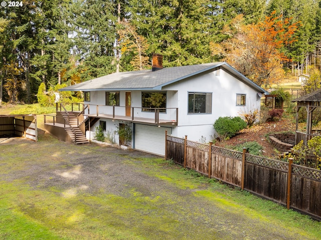 386 Longview Dr, Elkton, OR 97436 - view of front of house featuring a chimney, a garage, roof with shingles, stairway, and fence