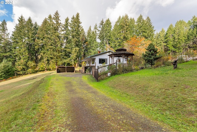 view of front of home featuring a gazebo and a front lawn