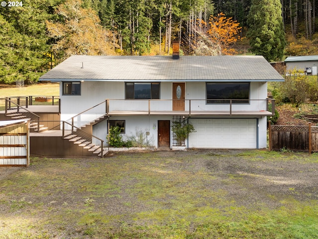 386 Longview Dr, Elkton, OR 97436 - rear view of house featuring stairs, a garage, roof with shingles, and fence