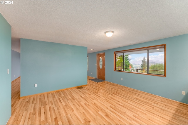 386 Longview Dr, Elkton, OR 97436 - unfurnished room featuring wood finished floors and a textured ceiling