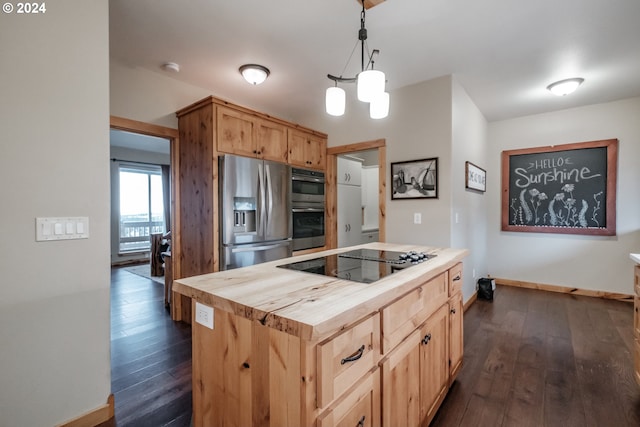 kitchen featuring decorative light fixtures, dark wood-type flooring, stainless steel appliances, and wooden counters