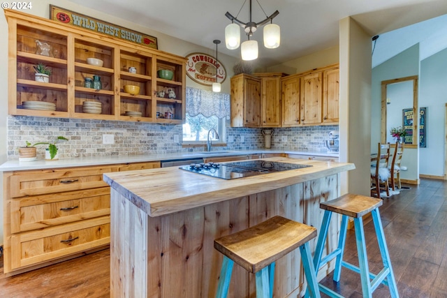 kitchen with wood counters, dark hardwood / wood-style flooring, black electric cooktop, and hanging light fixtures