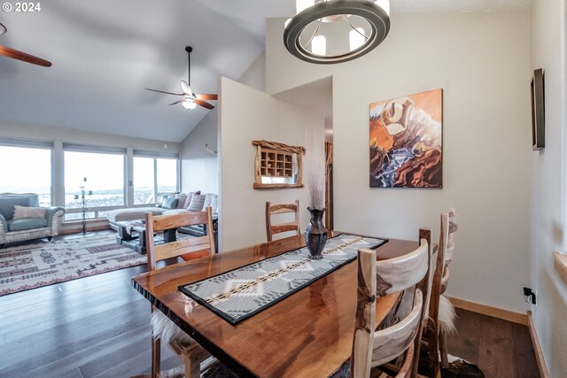 dining room featuring dark hardwood / wood-style flooring, high vaulted ceiling, and ceiling fan