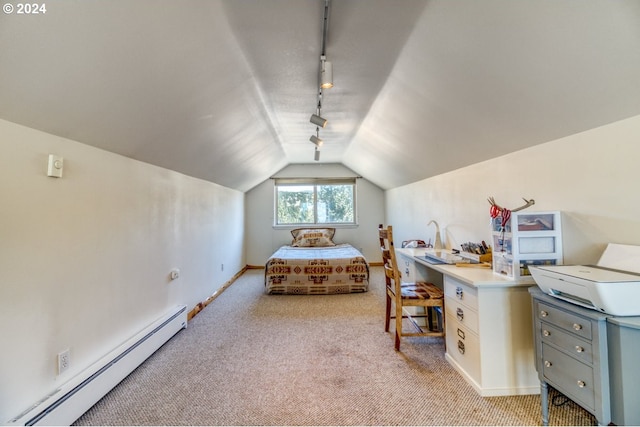 carpeted bedroom featuring track lighting, baseboard heating, and vaulted ceiling