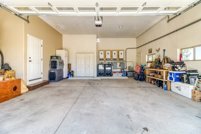 garage with white fridge and a garage door opener