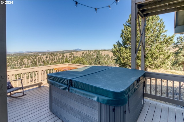 wooden terrace featuring a hot tub