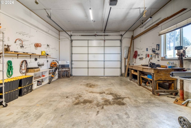 garage with a workshop area and a garage door opener