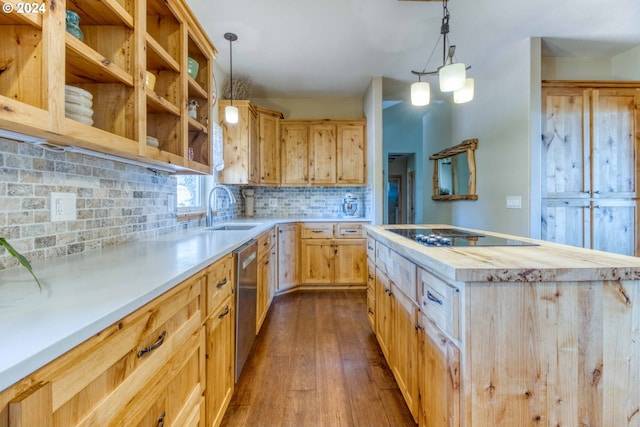 kitchen featuring sink, butcher block countertops, hardwood / wood-style floors, pendant lighting, and black electric stovetop