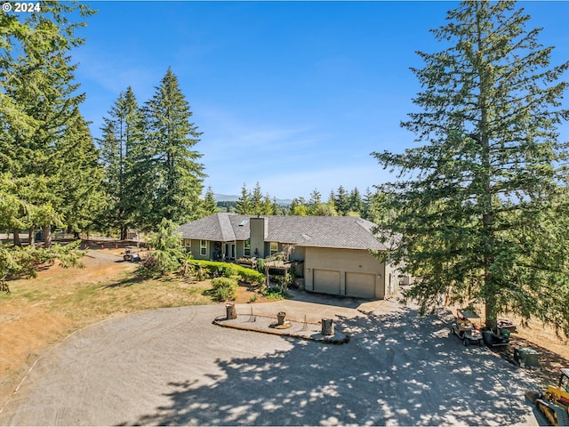 view of front of property with concrete driveway and a garage