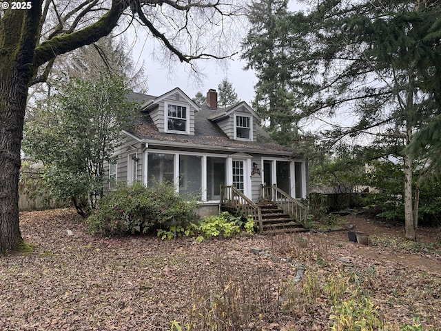 new england style home with a sunroom