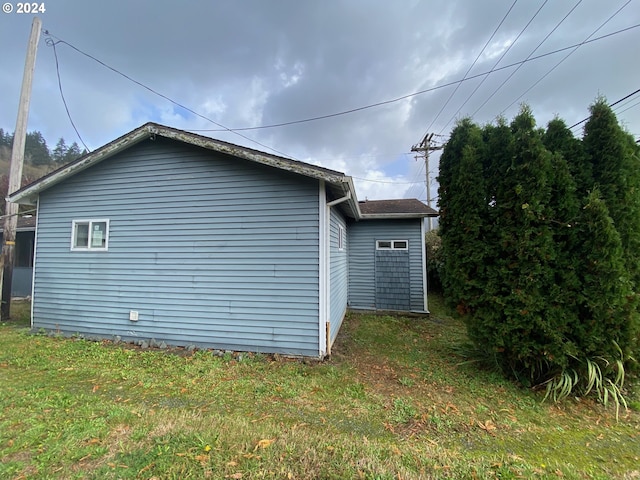 view of side of home featuring a yard