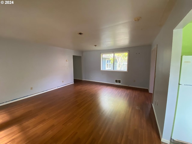 unfurnished room featuring dark wood-type flooring