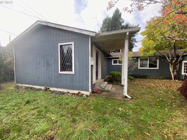 view of property exterior featuring a lawn