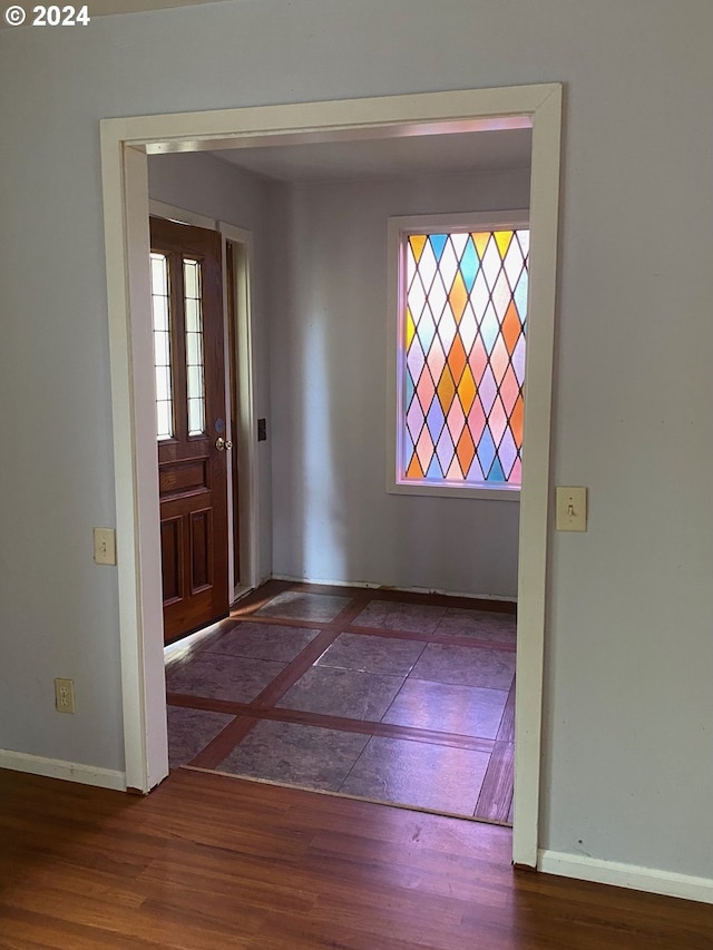 entryway with dark hardwood / wood-style flooring