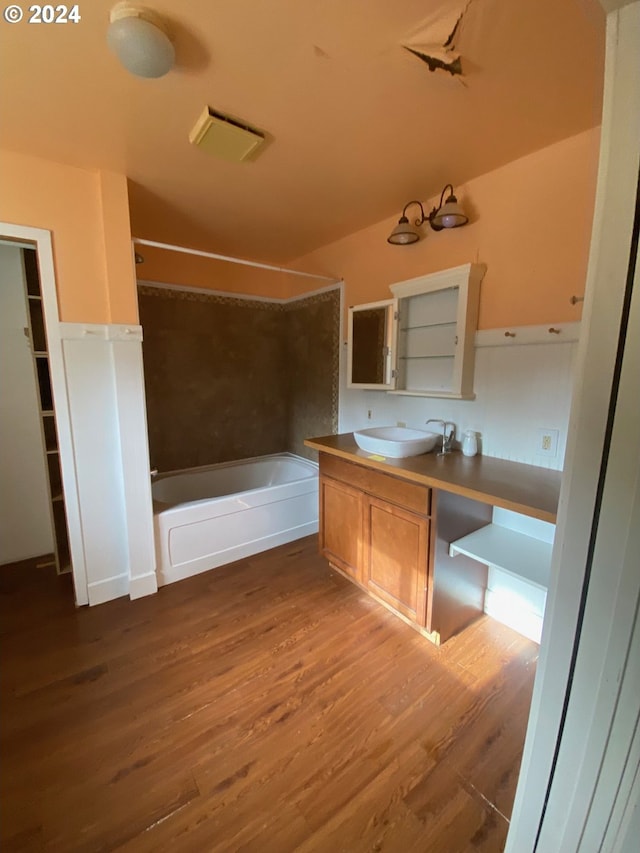 bathroom featuring  shower combination, wood-type flooring, and vanity