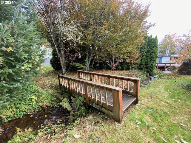 wooden terrace featuring a water view