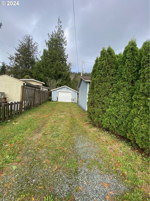 view of yard with an outbuilding and a garage